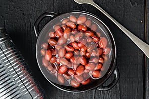 Japanese canned food ingredient, sweet red bean, on black wooden table background, top view flat lay