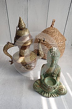 Japanese ceremonial tea kettle, buddha, and a basket