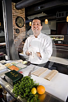 Japanese chef in restaurant with sushi ingredients