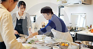 Japanese chef, women and cooking school with teaching, advice and knife for vegetables, ingredients or food. People
