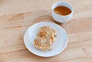 Japanese confectionery taiyaki fish cake wagashi on plate with t