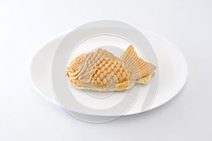 Japanese confectionery taiyaki fish cake wagashi on plate on white background