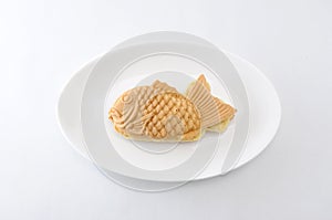 Japanese confectionery taiyaki fish cake wagashi on plate on white background