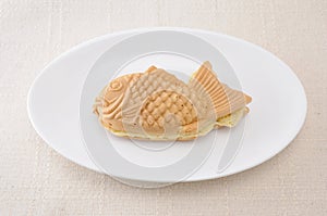 Japanese confectionery taiyaki fish pancake wagashi on plate on table