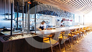 Japanese cooking counter with chefs making Omakase, sushi and sashimi in restaurant