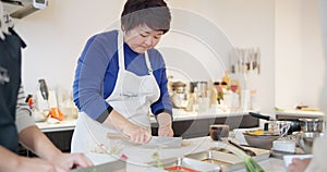 Japanese, cooking and woman with vegetables in home chopping with a knife on kitchen counter. Healthy, meal prep and