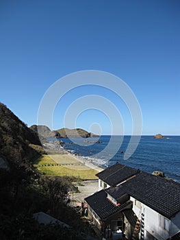 Japanese countryside rocky coast seaside with building and fields