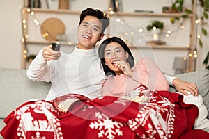Japanese Couple Watching TV On Christmas Eve Sitting At Home