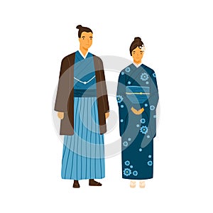 Japanese couple wearing traditional costumes. Man and woman in decorated national clothes yukata and hakama. Young