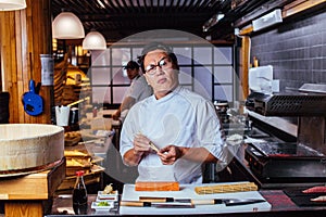 Japanese crazy chef with puzzled look in restaurant
