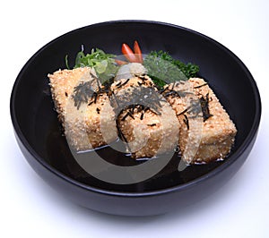 Japanese Crispy deep fried Tofu or Agedashi Tofu served in tentsuyu broth isolated on white background with clipping path