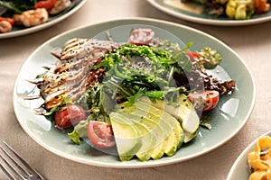 Japanese cuisine concept. Salad of eel, avocado pieces and chuka seaweed served on a plate in a restaurant