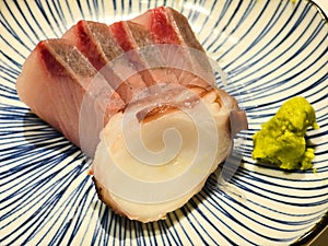 Japanese cuisine, featuring fresh sashimi of Yellowtail and Octopus. Seriola quinqueradiata.