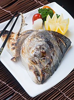 japanese cuisine. fried fish head on the background