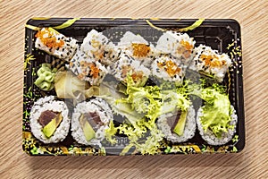 Japanese Cuisine: Tasty Uramaki and Futomaki served in the take-away box