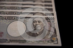 Japanese currency 100,000 yen on the black background closeup
