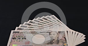 Japanese currency 100,000 yen on the black background focusing