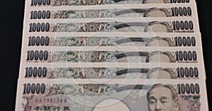 Japanese currency 100,000 yen on the black background tilt