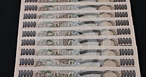 Japanese currency 100,000 yen on the black background tilt