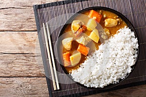 Japanese curry rice with meat, carrot and potato close-up on a p photo
