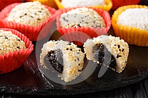 Japanese dessert mochi daifuku with anko and sesame close-up. Horizontal