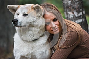 Japanese dog Akita inu portrait with young woman outdoors