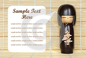 Japanese doll on bamboo mat