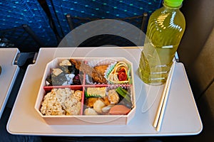 Japanese Eki Bento and a bottle of green tea on a Shinkansen Train in Japan.