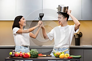 Japanese Family Fencing With Cooking Tools Having Fun In Kitchen