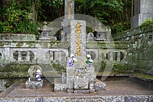 Japanese family grave decorated with flowers and offerings in old Chinese Kofukuji-Temple, Nagasaki, Japan.