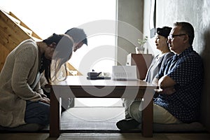 Japanese family greeting bowing with senior