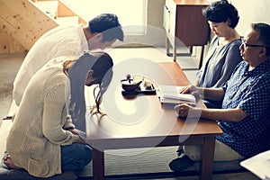 Japanese family paying respect to adult