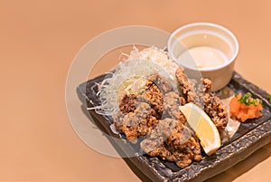 Japanese fish dish of marinated fried whale called kujira no tatsutaage served with shredded cabbage.