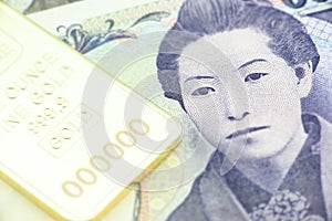 Japanese five thousand yen bill, a macro close-up with gold bullion.