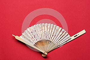 Korean folding fan on red background