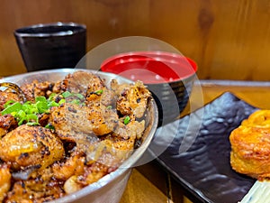 Japanese food called Tori Don or Chicken Rice Bowl served with miso soup and fried egg roll