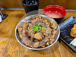 Japanese food called Tori Don or Chicken Rice Bowl served with miso soup and fried egg roll