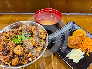 Japanese food called Tori Don or Chicken Rice Bowl served with miso soup and fried egg roll