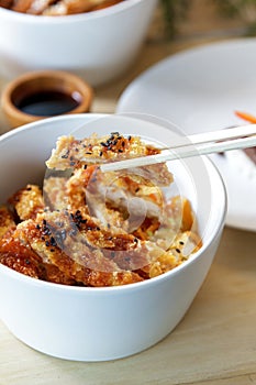 japanese food chicken katsu don served in white bowl with chopsticks