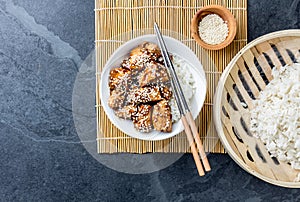 Japanese food. Chicken teriyaki with rice. slate background, top view