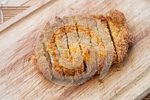 Japanese food, deep fried porkchop Tonkatsu on chopping wood