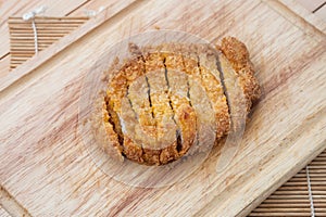 Japanese food, deep fried porkchop Tonkatsu on chopping wood