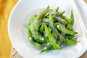 Japanese food edamame nibbles, boiled green soy beans