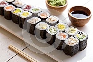 Japanese food mini maki sushi platter on white wooden table