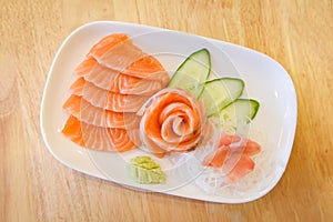 Japanese food raw sashimi salmon fillet with vegetable cucumber and wasabi in the restaurant / Salmon sashimi menu set Japanese