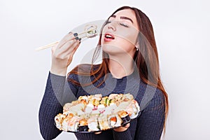 Japanese food, restaurant concept. Young beautiful woman enjoy e