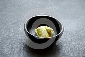 Japanese food style, Selective focus of mustrad wasabi in black ceramic cup