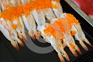 Japanese food sushi roll with Tobiko egg is orange flying fish roe on shrimp prawn in the restaurant sushi menu set Japanese