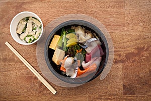 Japanese food Tekka Don take away on wooden background