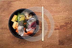 Japanese food Tekka Don take away on wooden background